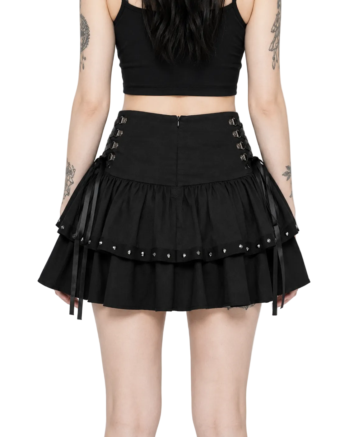 Person wearing a black skirt with lace-up details on a white background