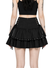Person wearing a black skirt with lace-up details on a white background