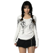 Woman wearing a white long-sleeve top with black floral patterns and a black skirt on a white background
